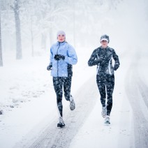 Two women run down Mountain Avenue in a snowstorm.